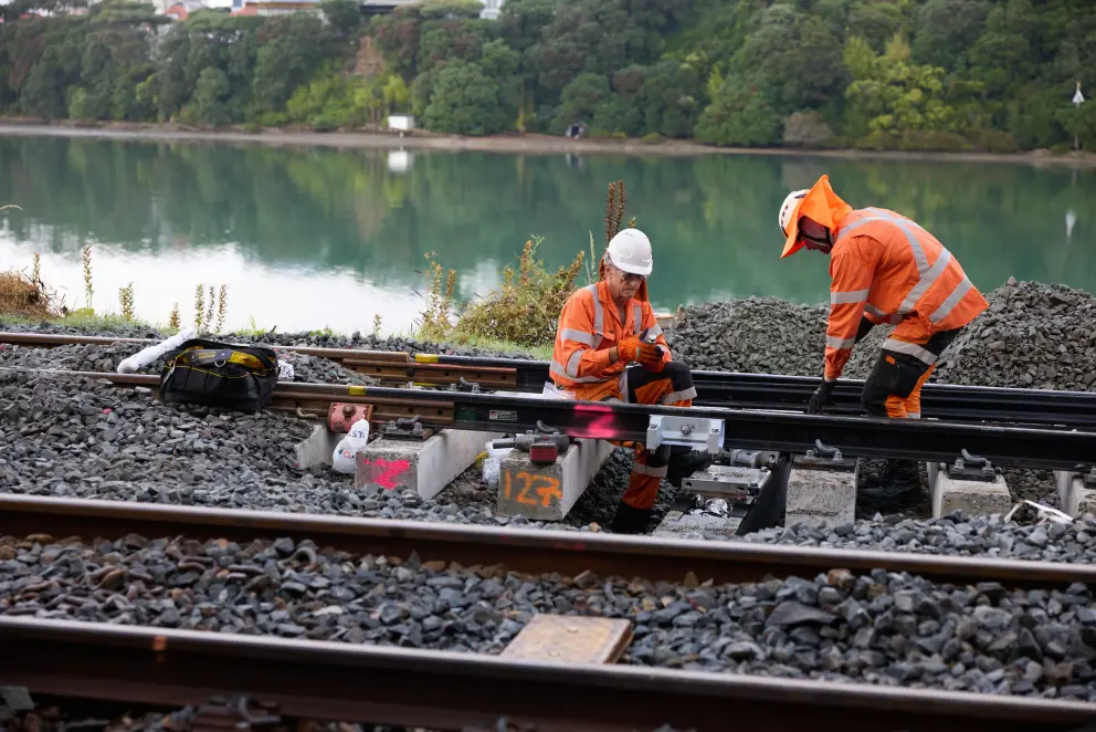 Auckland metro track maintenance by a river