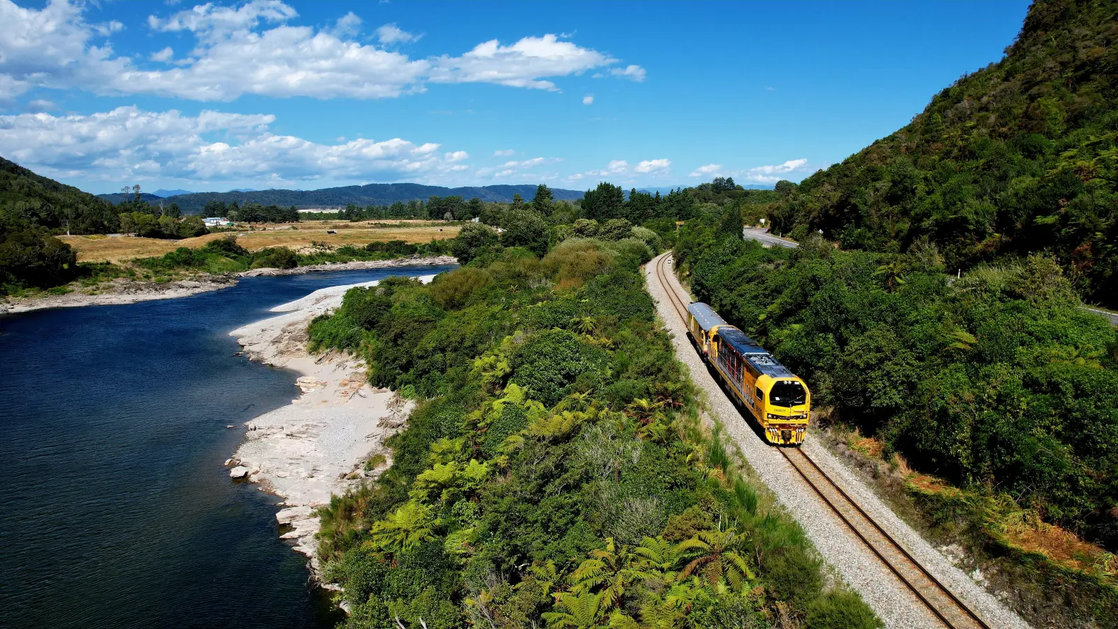 DM locomotive pulling a test car by river