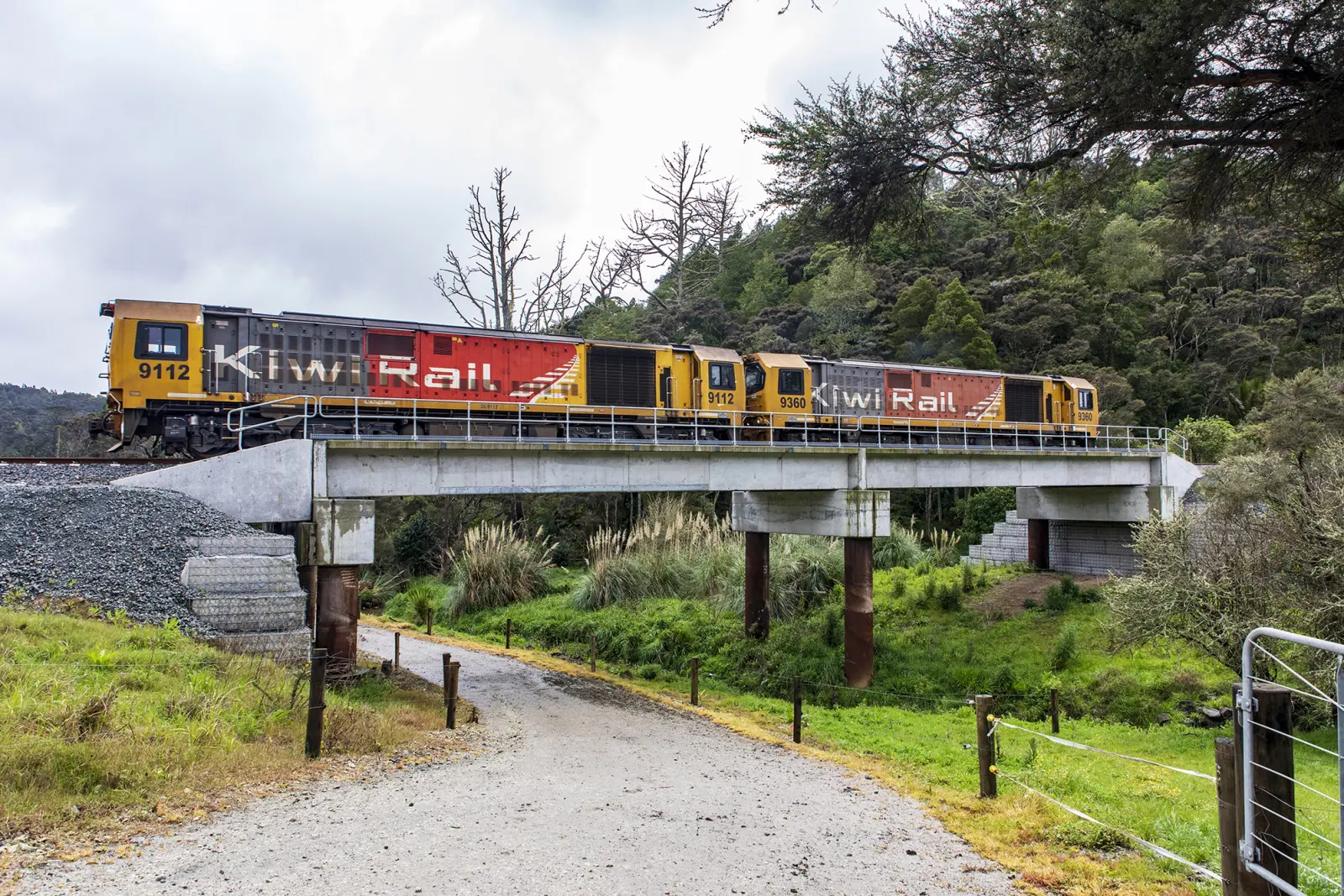 Two-carriage locomotive going over steel bridge
