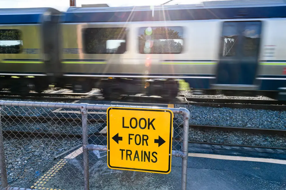 Look for Trains sign in front of moving train