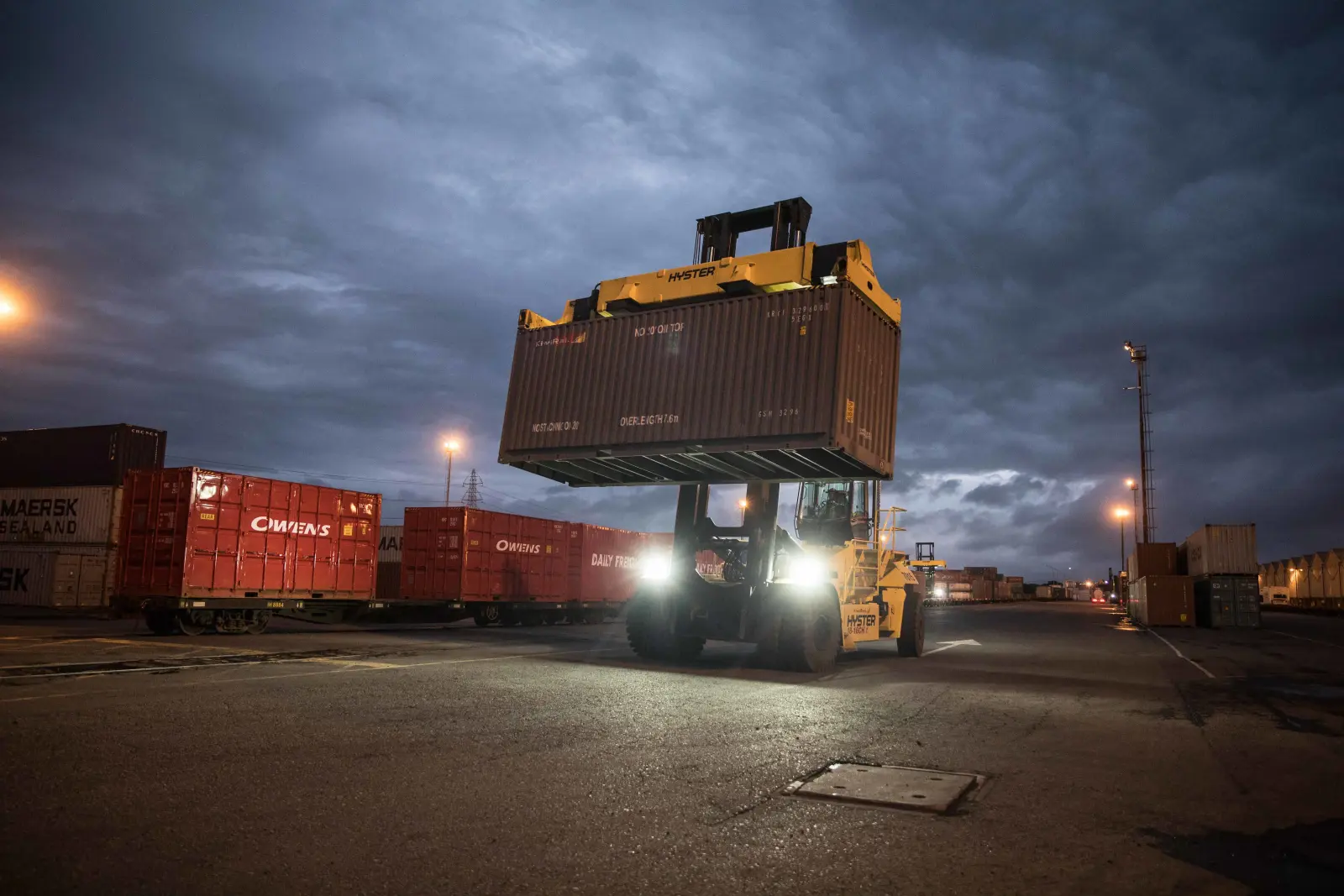 Side loader moving a freight container