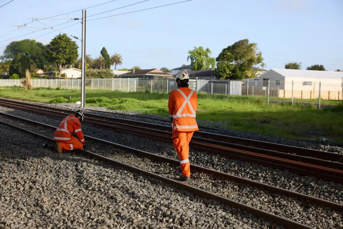 Workers in high-vis maintaining railway track