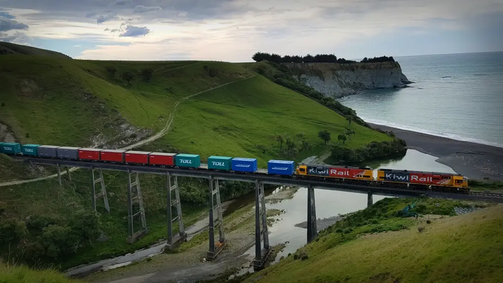 Loco pulling freight carriages over a high viaduct