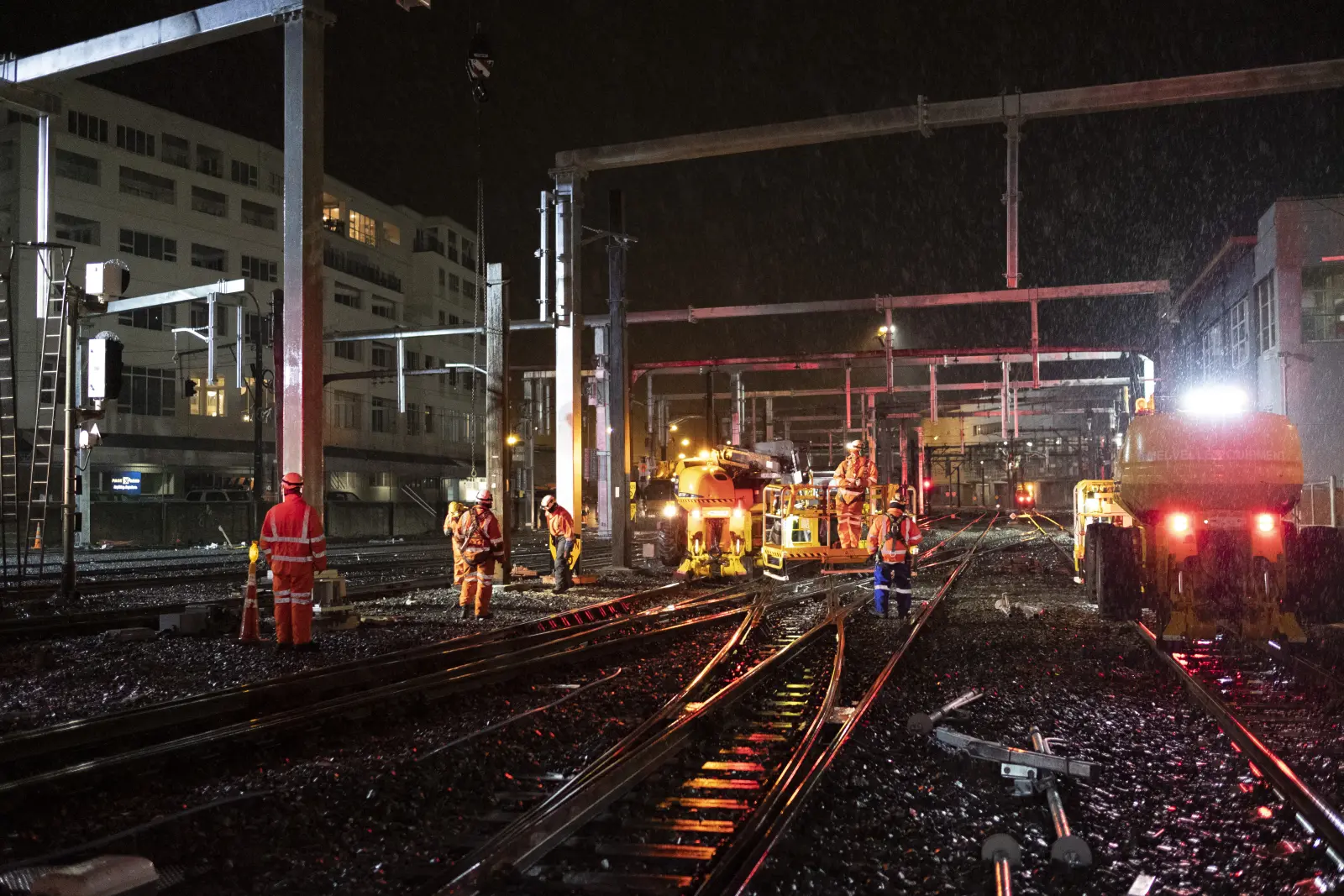 Maintenance workers fixing track at night