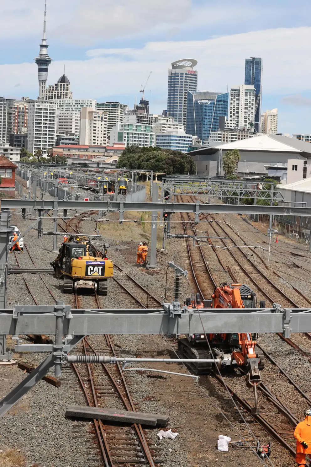 People and diggers working on rail