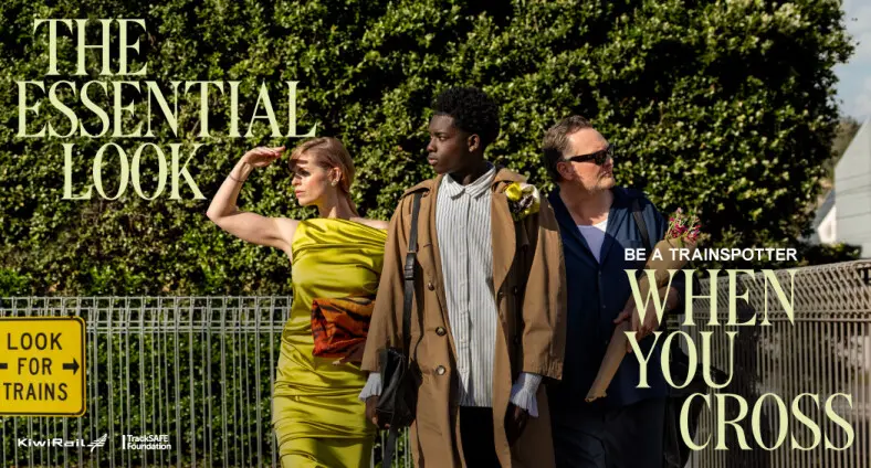 1 woman, 2 men, looking for trains at a level crossing in fashionable clothing. The words "the essential look when you cross" are there